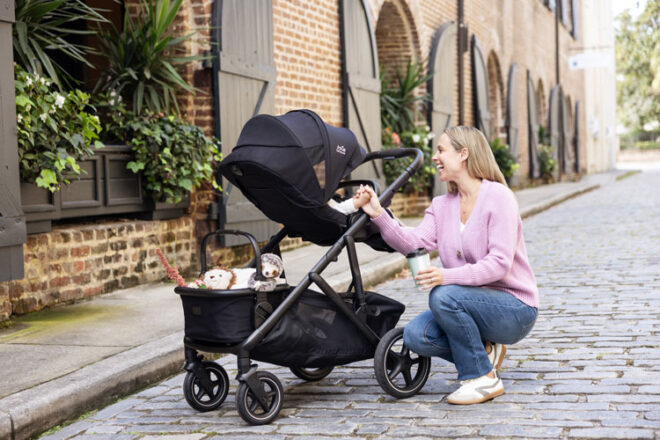 Mother with baby in Joie Versiti pram with carry basket attached