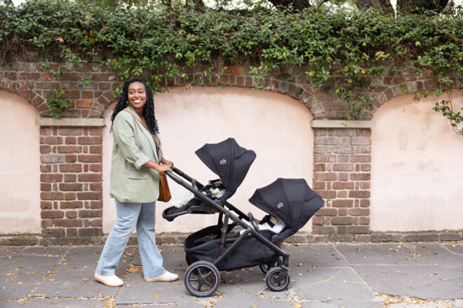 Mother pushing the versiti double stroller