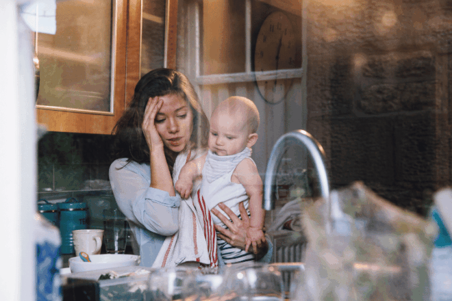 Breastfeeding mother nursing her baby by a window as cluster feeding eases