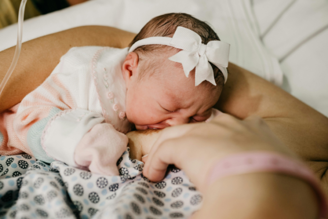 Newborn baby falling asleep at the breast during a cluster feeding stretch