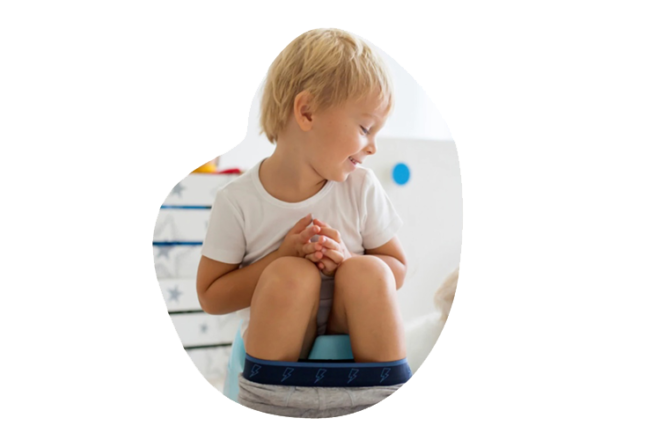 young boy sitting on potty