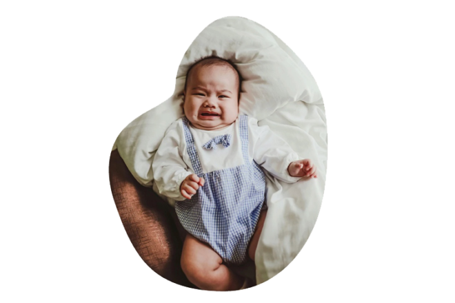 crying baby teeething on bed